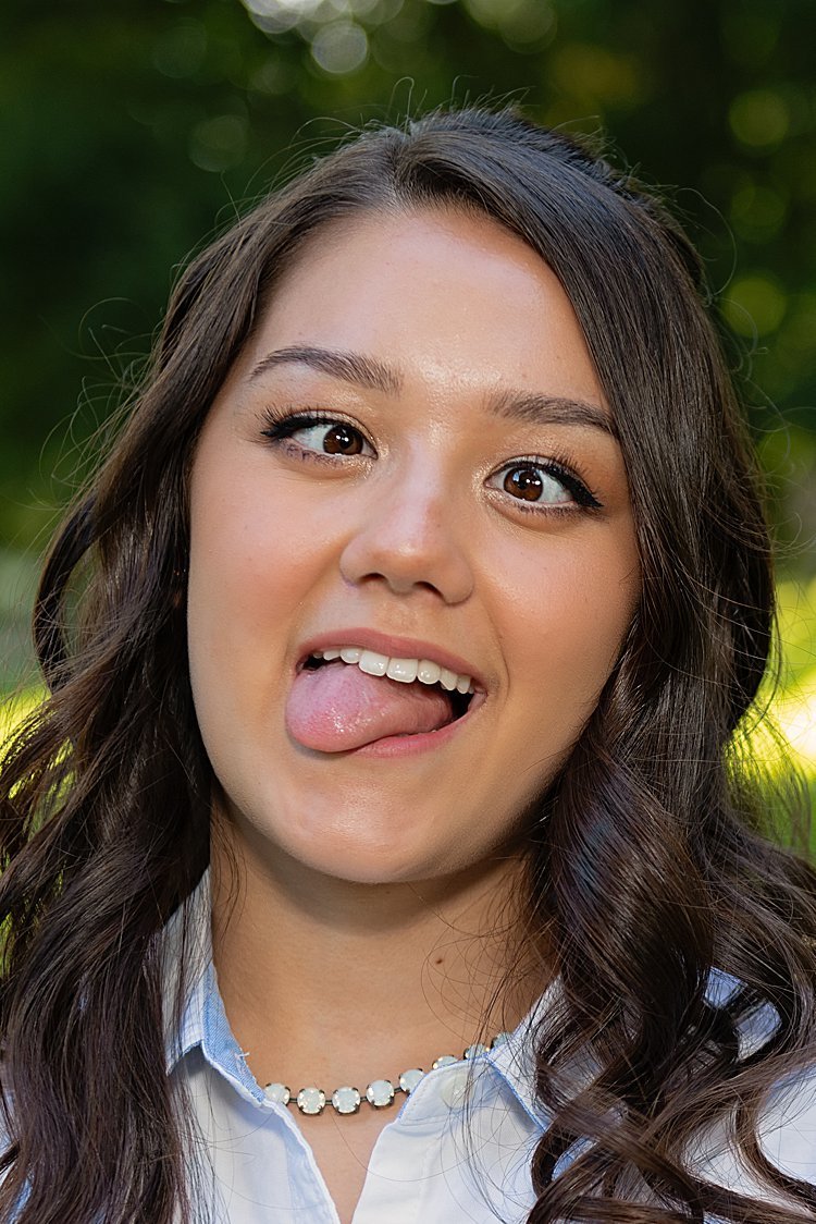 Close-up of. high school senior girl crossing her eyes and sticking out her tongue
