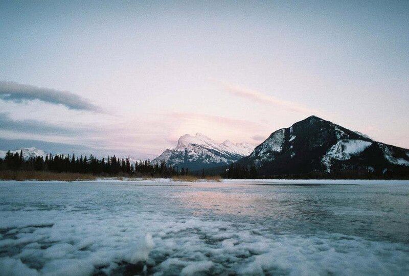 Overlooking an icy lake in Toronto out to a snow-capped mountain