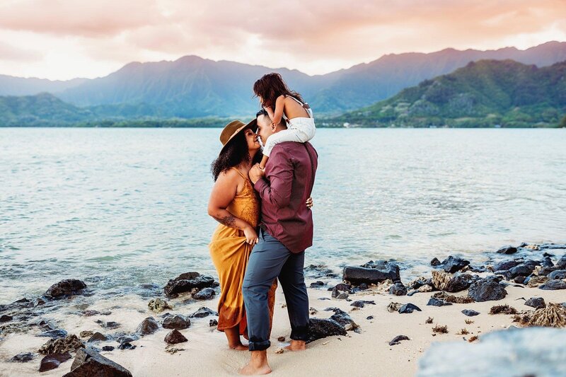 interacial family kissing dunring sunset in Hawaii