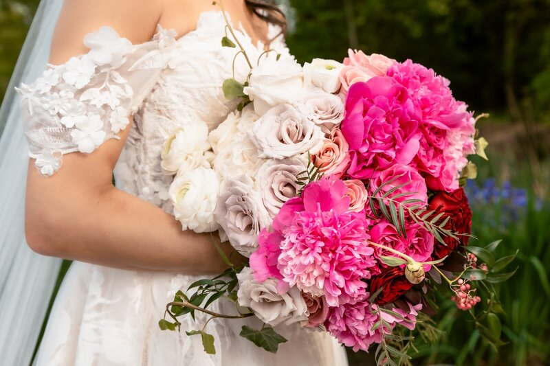 close up of bride holding pink and white bouquet