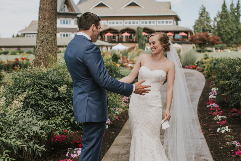 real bride wearing a floor length veil and sharing a first look with her groom