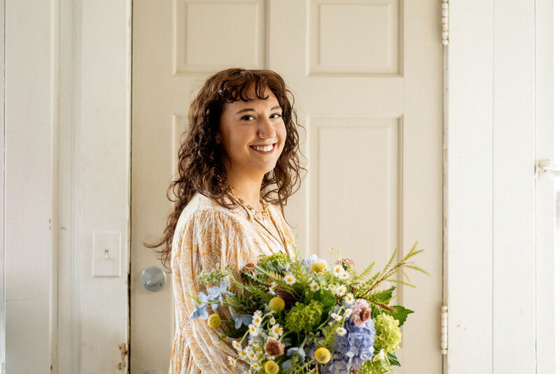 Pittsburgh wedding florist Heavenly Blooms holding large floral bouquet 