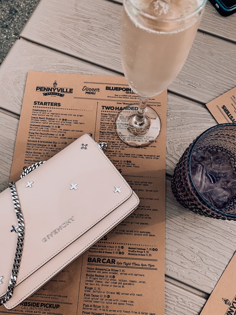 Styled tablescape of menu with galsses and givenchy handbag photo by AMALYN STYLE + SOCIAL 
