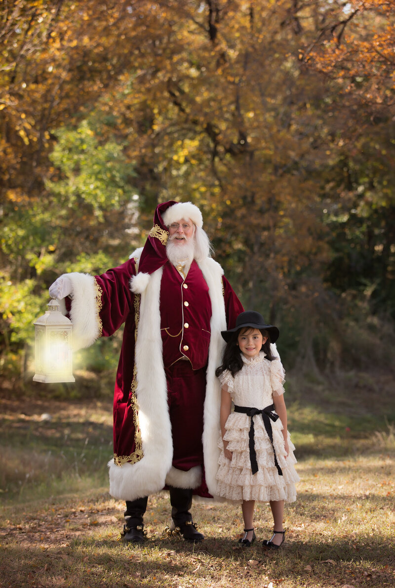 girl-standing-with-santa-in-the-park