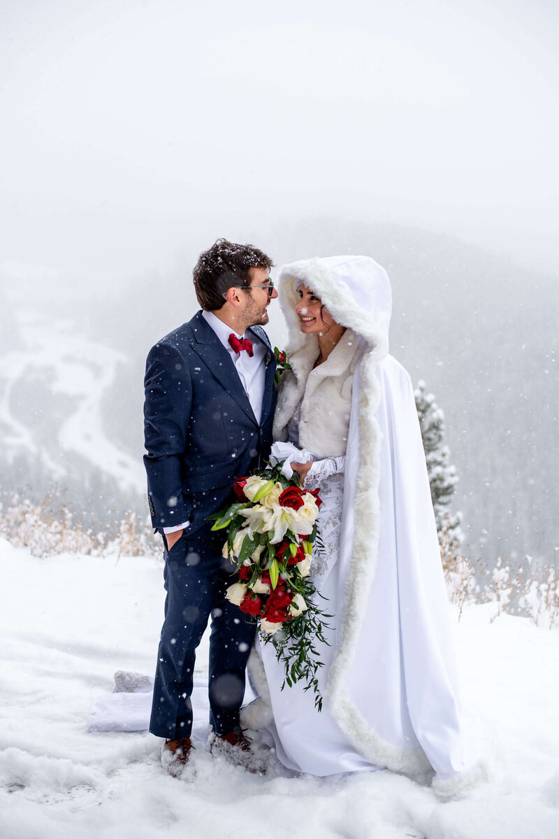 Bride and groom enjoy a snow storm in the Colorado mountains during their adventure elopement.