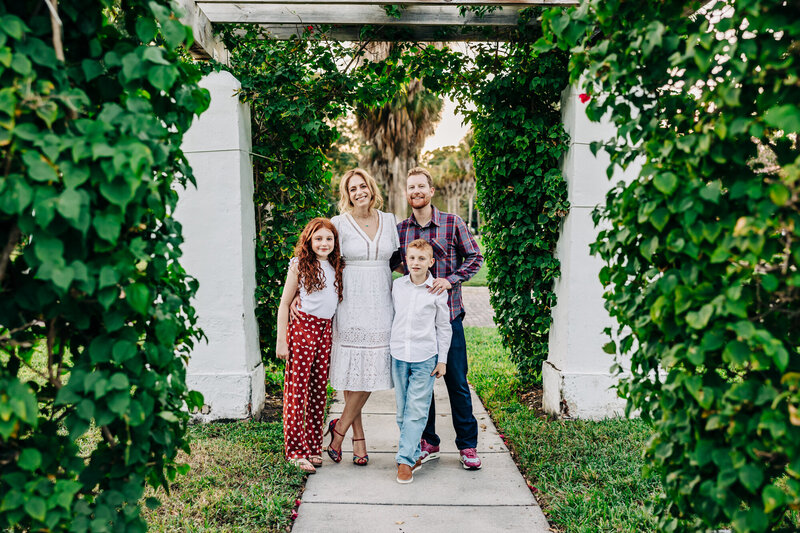 Joyful family moments captured in a holiday mini session near historic structures.