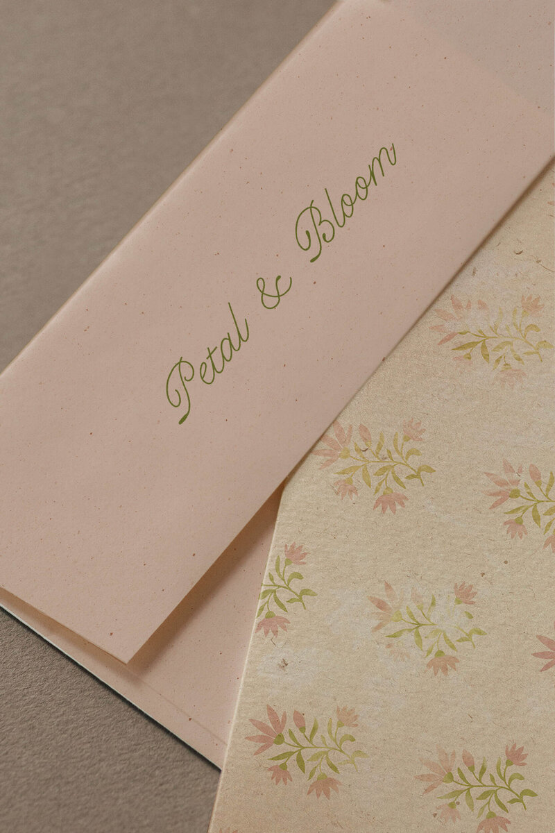 a pink envelope and a floral printed card