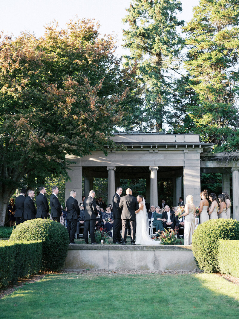 ceremony view with a mansion in the background