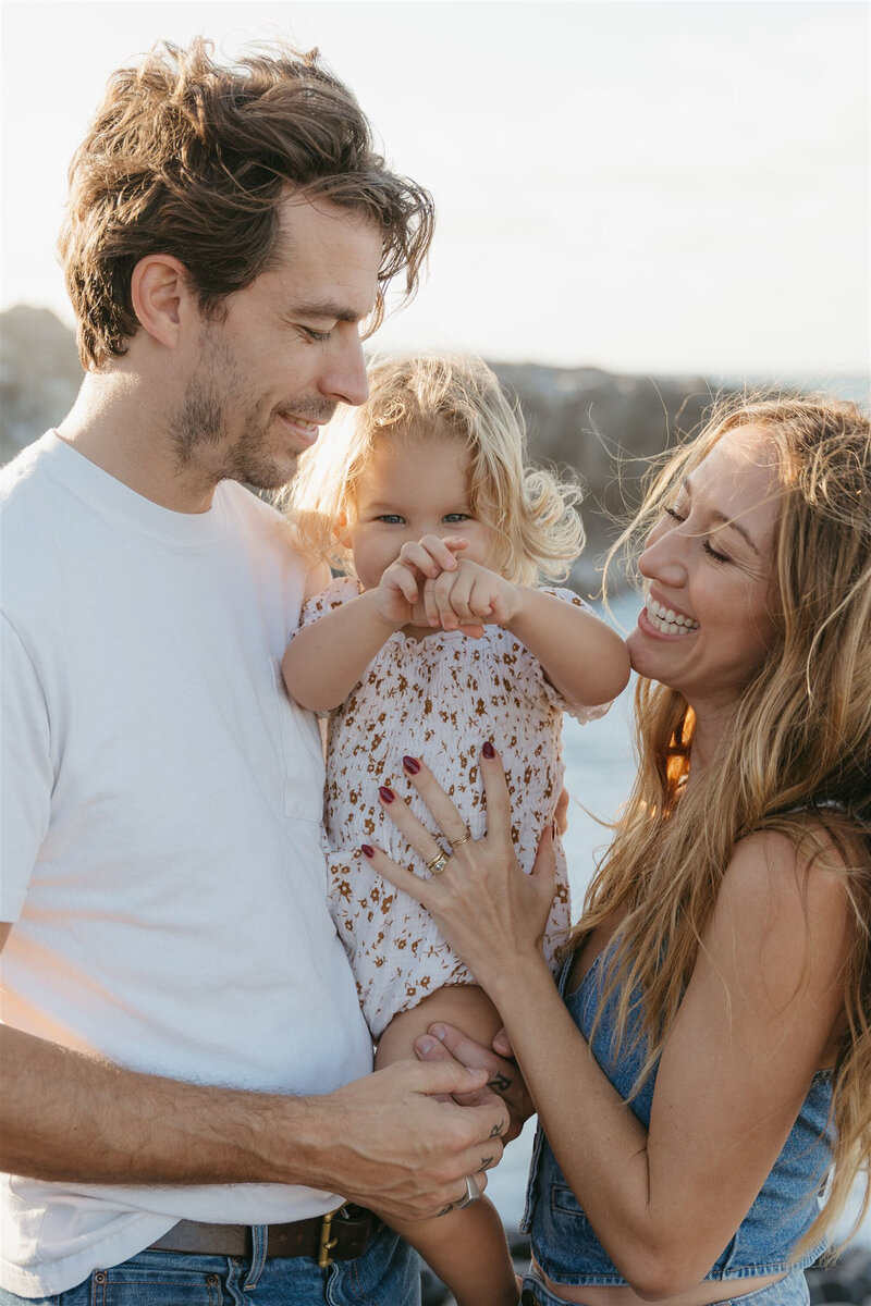 Parents and children embracing during a styled family photo shoot in Maui, golden hour editorial session.