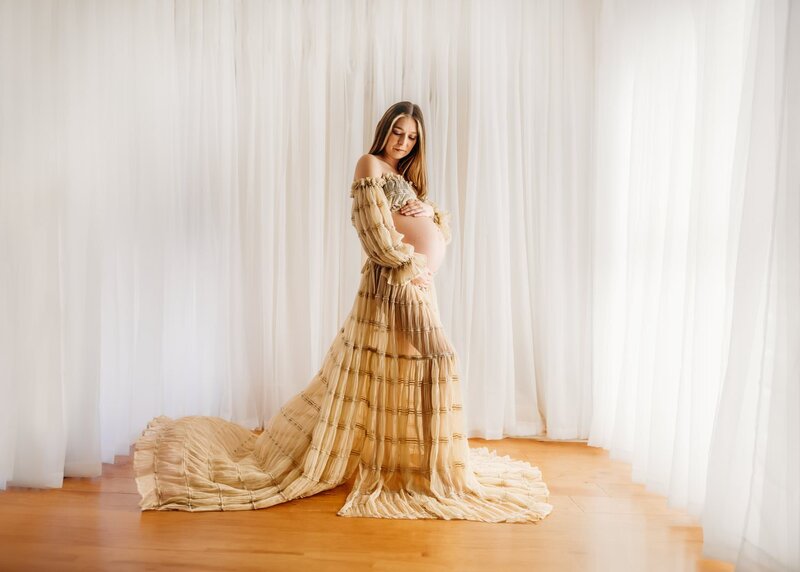 pregnant mom in a walnut creek open space wearing blue maternity gown