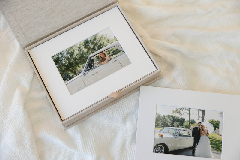 Folio box with a matted print of a bride sitting in a vintage car