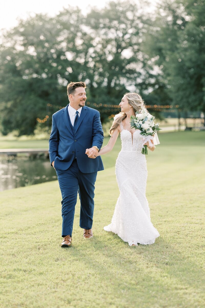 bride and groom walking while holding hands