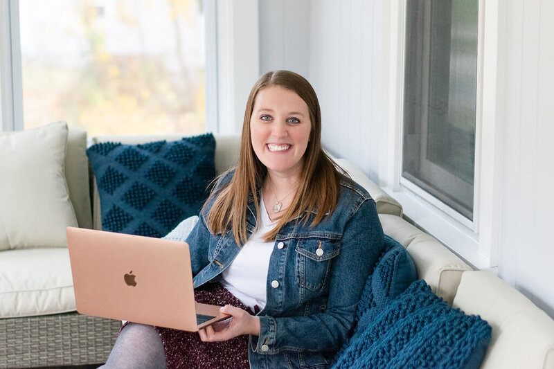 Best Newborn and College Grad Photographer in Worcester, MA holding her computer