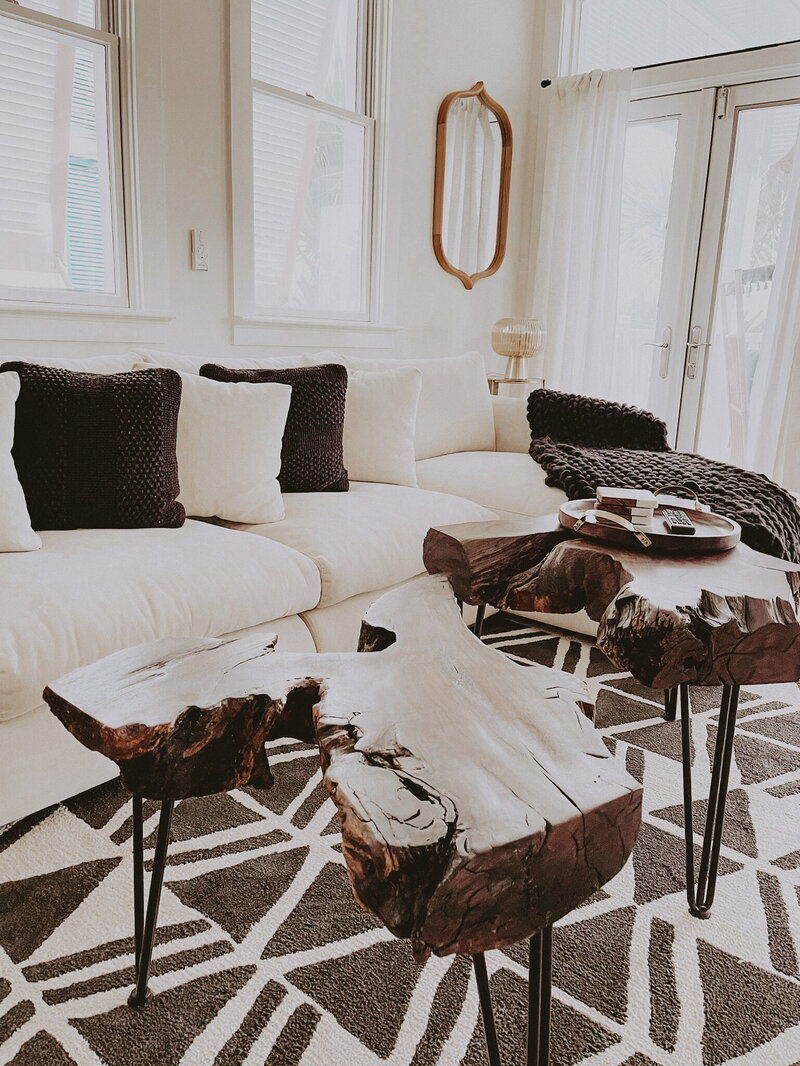 white sofa with black accent throws and a wood coffee table