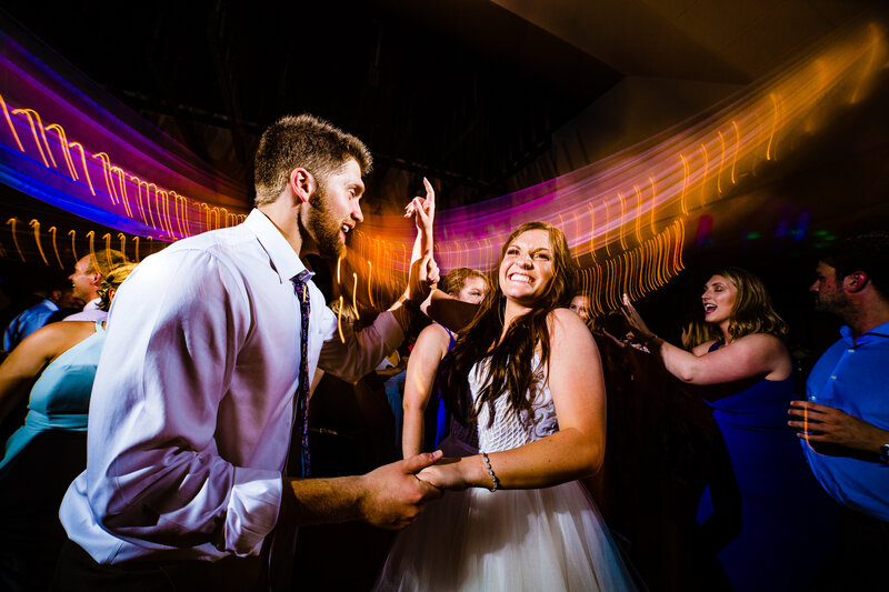 Bride and groom partying on the dancefloor having fun
