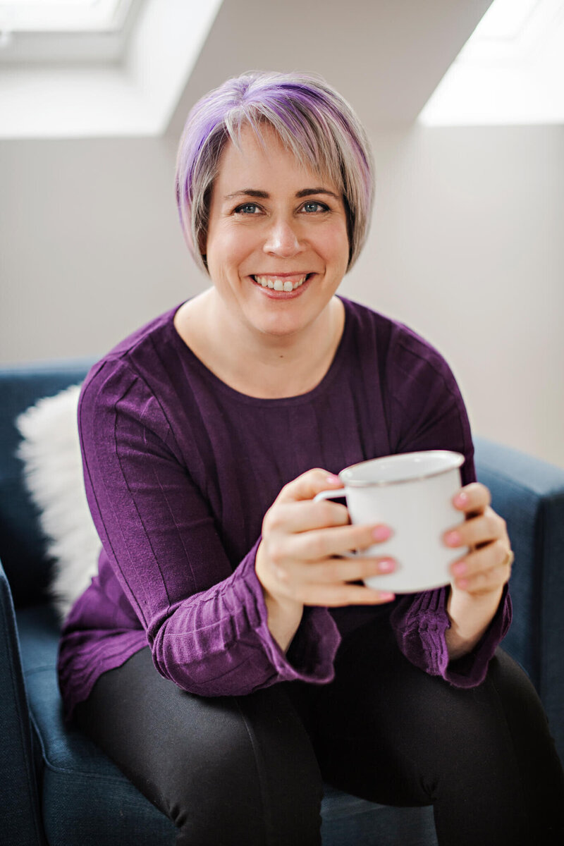 Heather Cook, the Social Stager, smiling at the camera with a mug of tea.