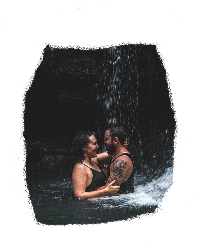 Couple being photographed under a waterfall