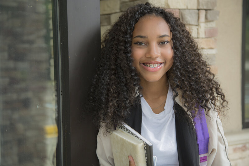 girl smiling holding books