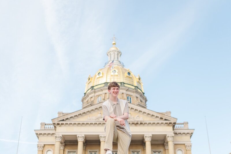 a young man posing in front of a building with stunning architecture