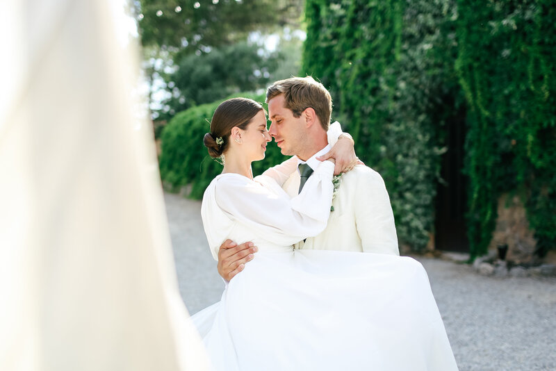 groom-carries-bride-at-luxury-destination-wedding-in-provence