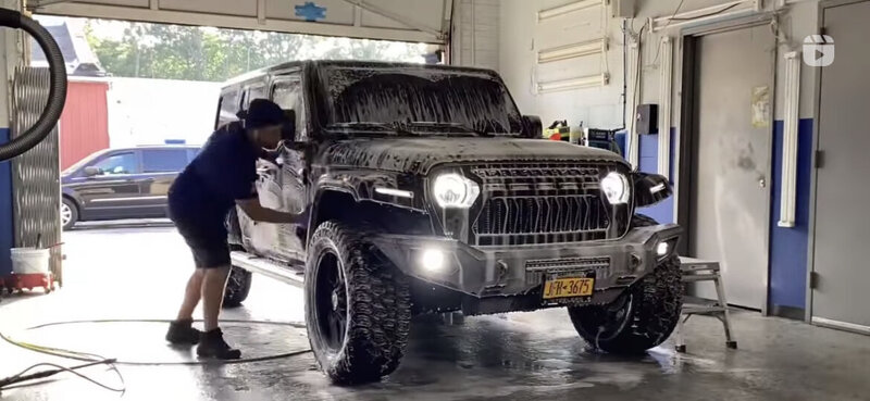Black Jeep undergoing expert car detailing at Superstar Auto Spa. This image highlights our specialized auto detailing services, including interior and exterior cleaning, paint correction, and ceramic coating for off-road vehicles.