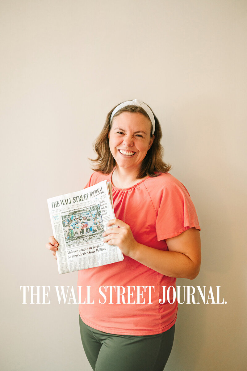 Photographer Kristen Hazelton holding a copy of the Wall Street Journal