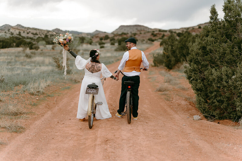 bride and groom riding on bikes