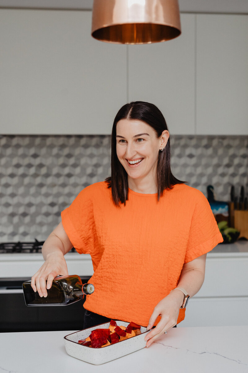 Nutritionist in Perth in kitchen talking about her nutrition podcast