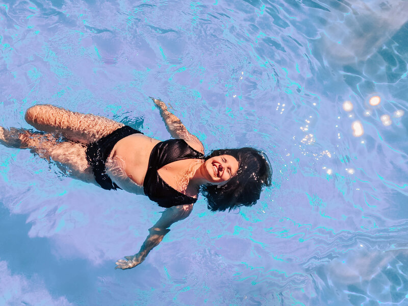 girl laying in the pool