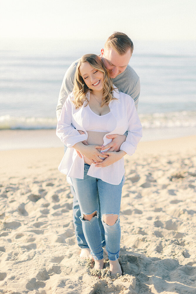maternity couple hugging