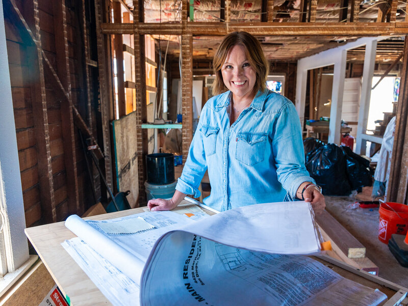 Courtney Murphy at a construction jobsite reviewing blueprints