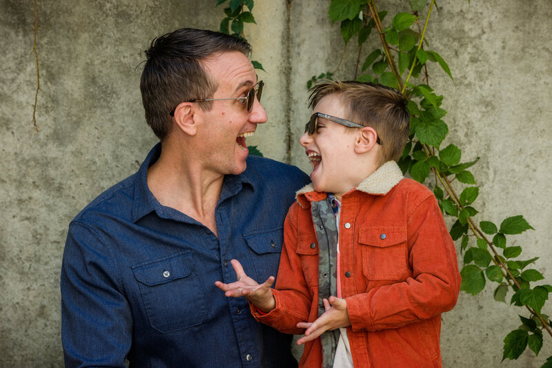 father and son looking and laughing at each other