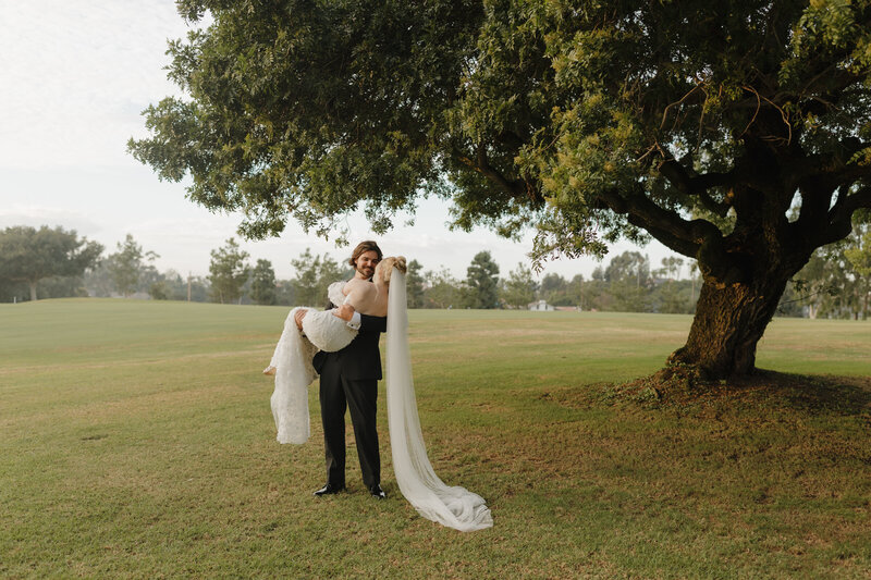 Couple on their wedding day exploring a golf course