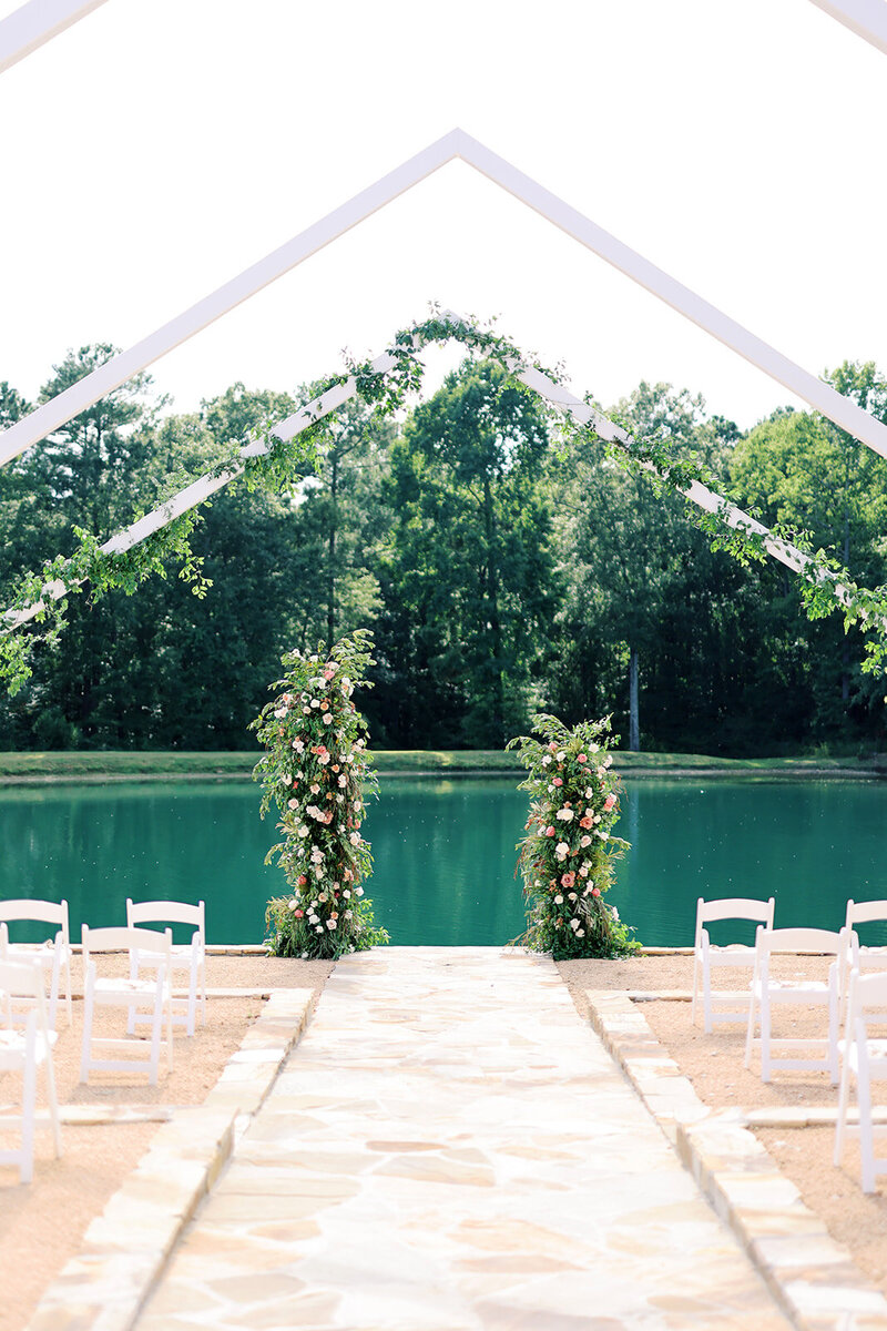 white open air chapel at walnut hill with couple and colorful flower arch