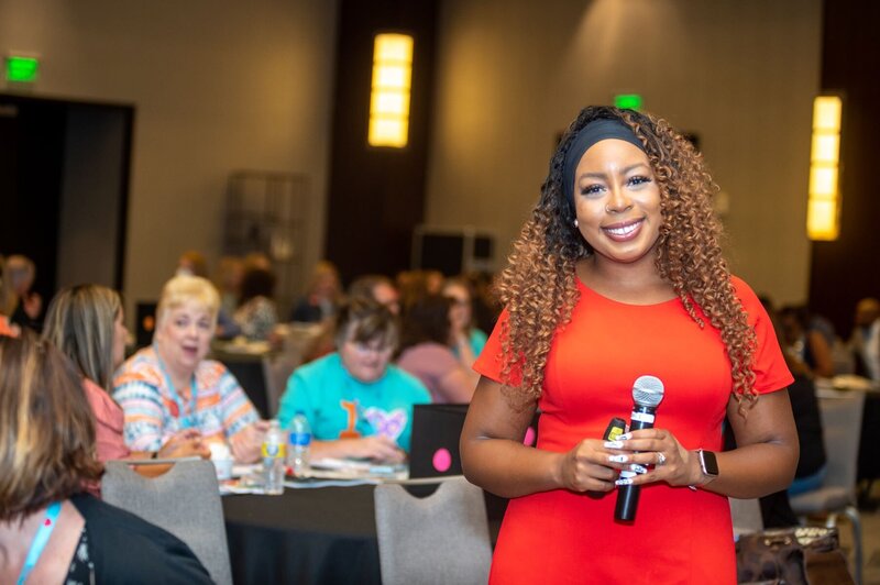 Dr. Deonna Smith holding a microphone