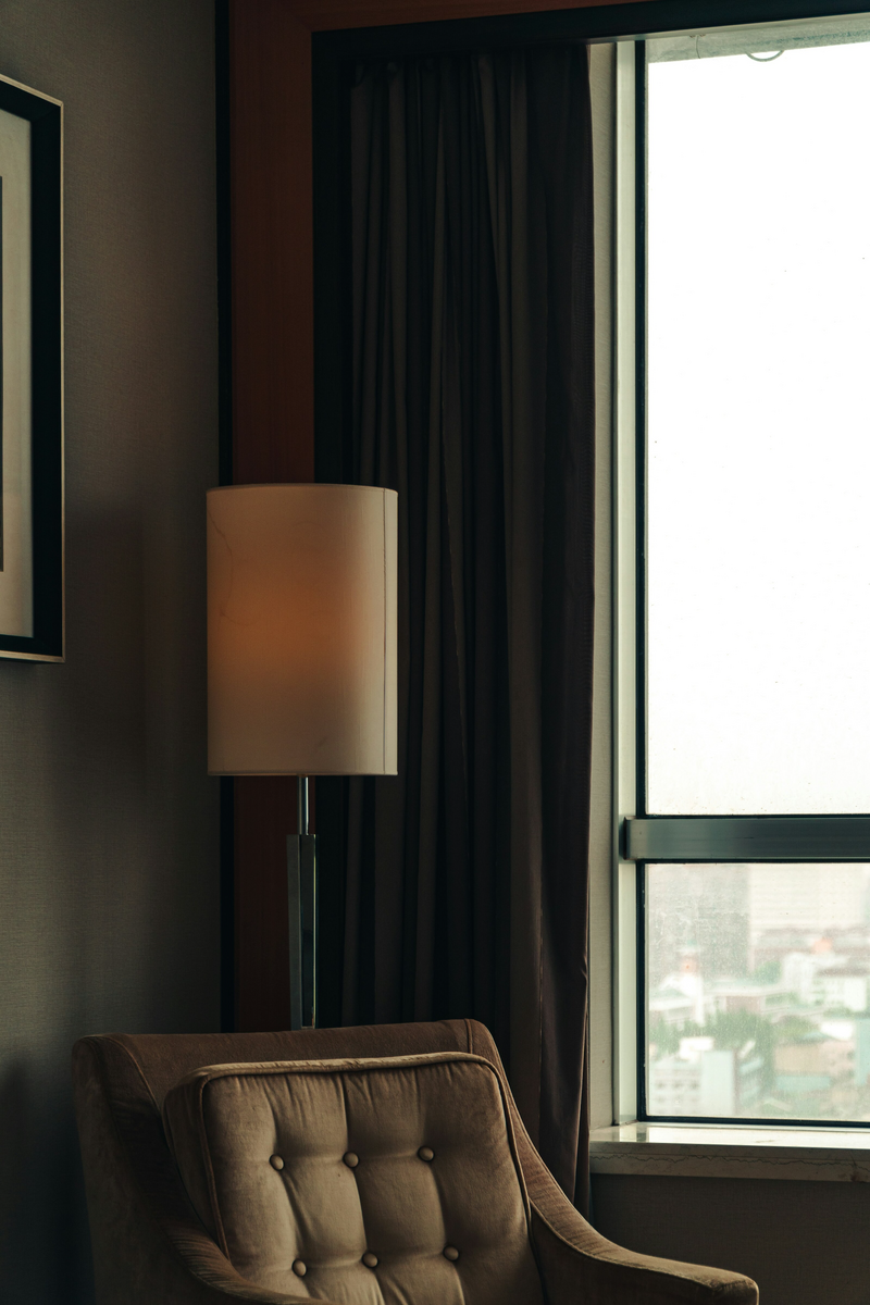 high end arm chair with floor lamp behind 