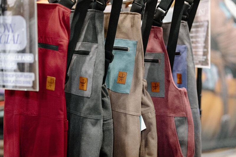Woman's coveralls hanging on a rack at an agricultural trade show captured by a brand photographer