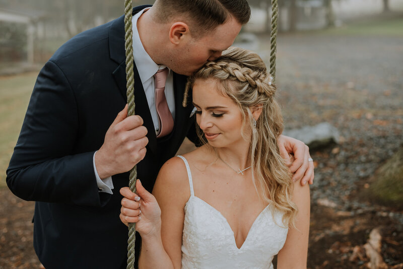 bride and groom on swing at the grove at kemptom