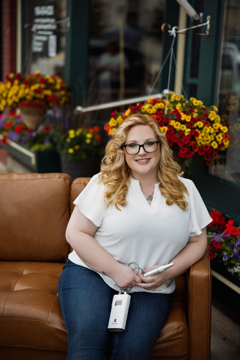 Jaci Knight, nail technician at Intrigue Salon, holding nail polish color samples in the salon.