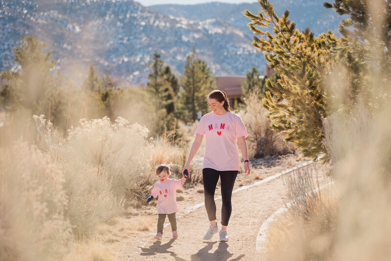 Mom and little girl walk a foothills trail.
