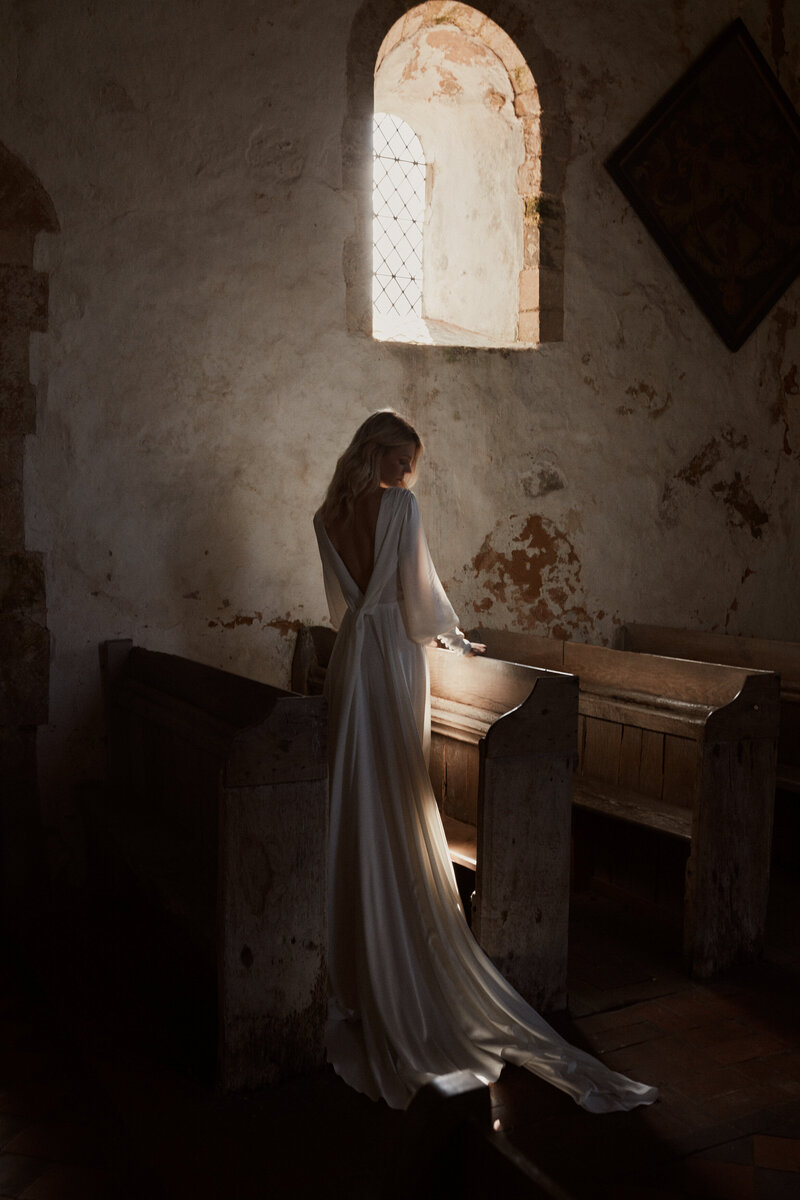 Low v-neck long-sleeved wedding dress in silk on a bride