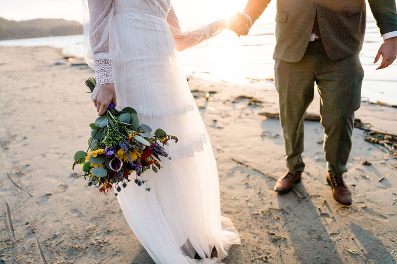 couple holds hands after getting married at olympic national park