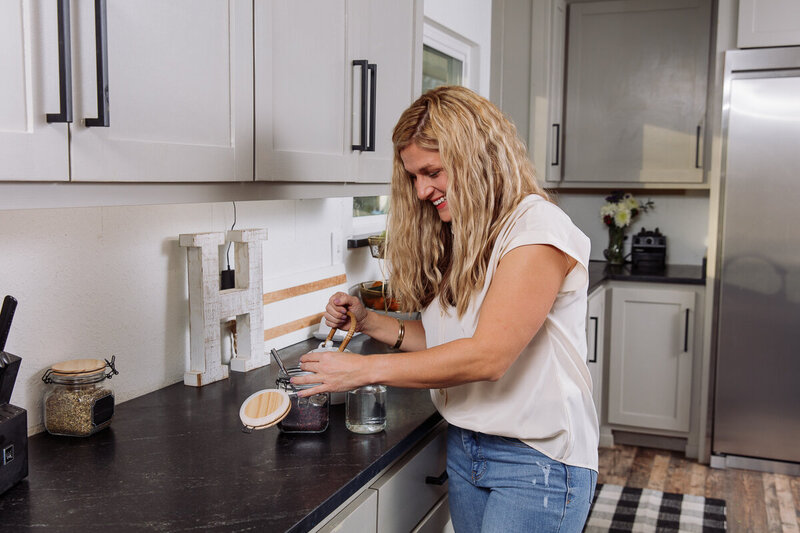 Amy taking her daily supplements as part of a balanced wellness routine.