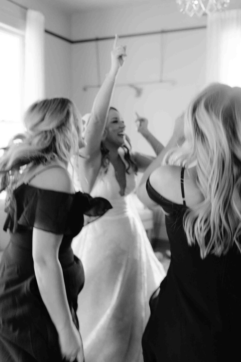 bride dances with bridesmaids