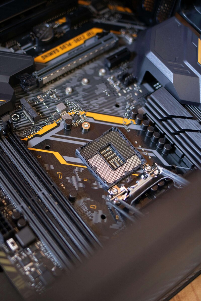 Close-up view of a computer motherboard with intricate circuits and a visible CPU socket, symbolizing advanced technology and engineering.
