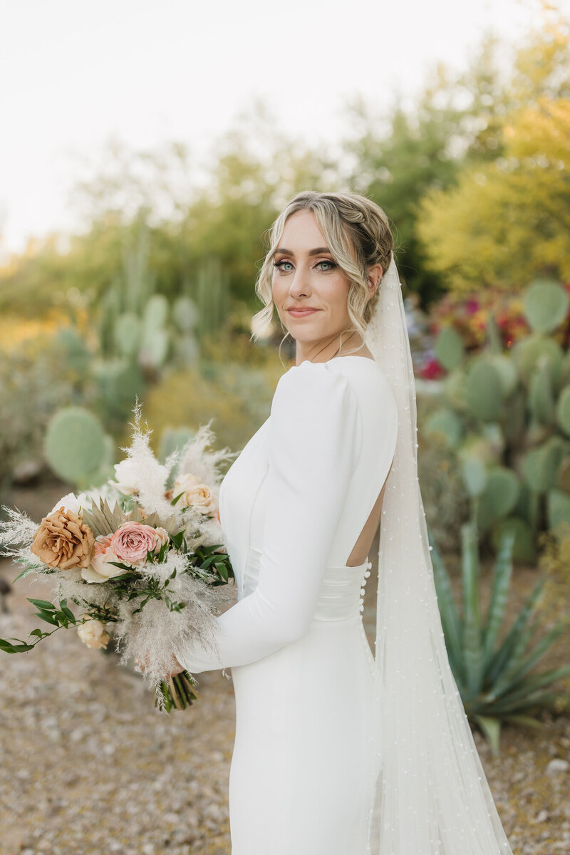 Bride smiling at camera during portraits at El Chorro in Paradise Valley, Arizona.