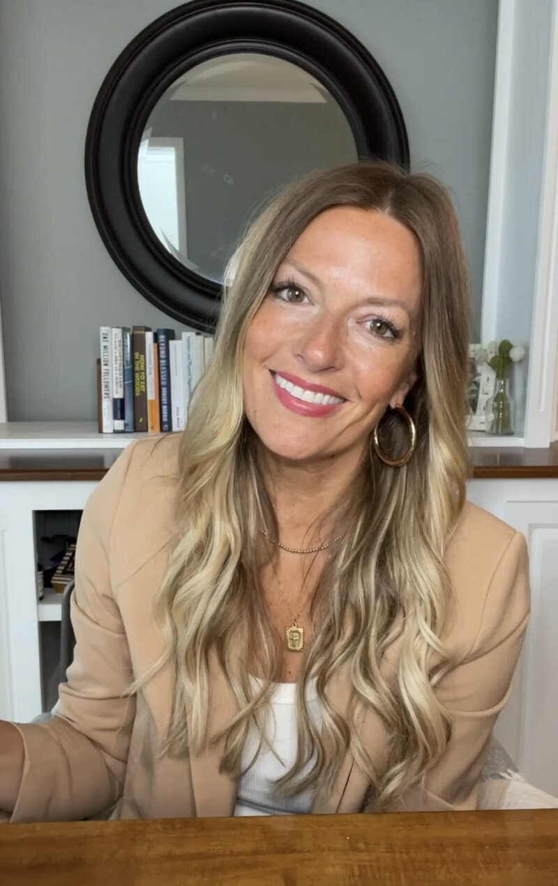 ultrasound business coach, Jennifer Lindsey, sitting at a desk smiling