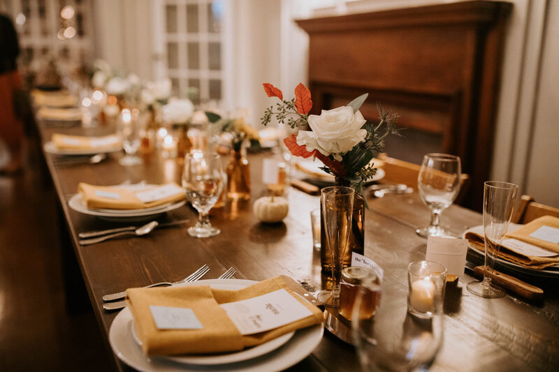 Table set with white plates and flower arrangements in the middle