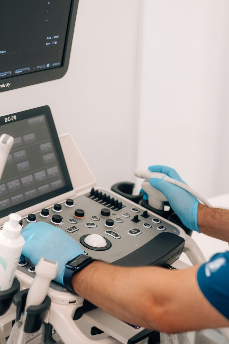 vet operating an ultrasound machine