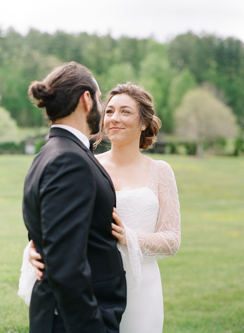 Bride looking at Groom with Wind Blowing Her Hair Photo